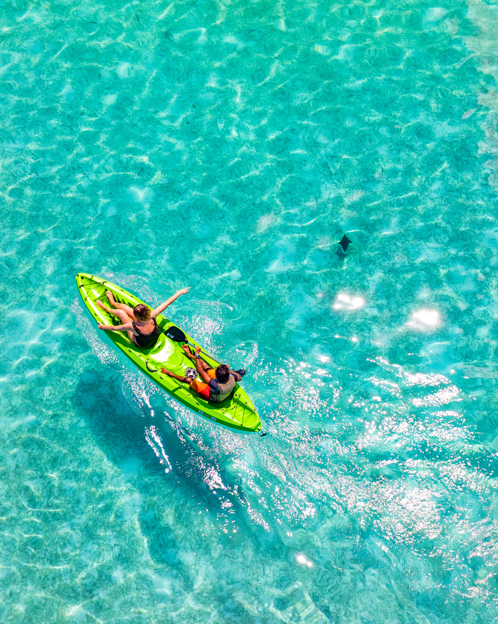 Woman floating in crystal clear water