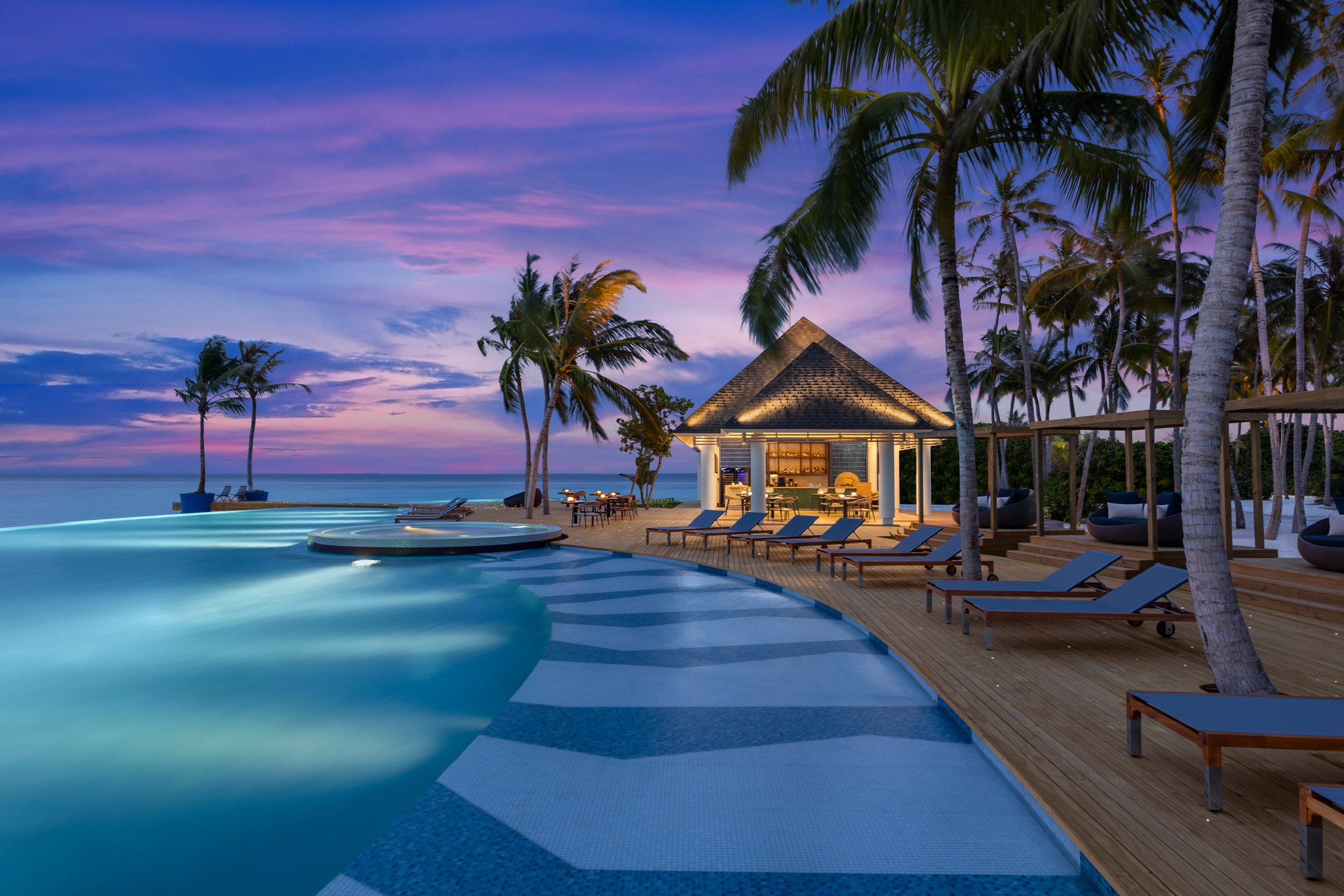 Luxury resort pool at sunset